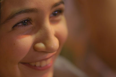 Close-up of smiling young woman looking away