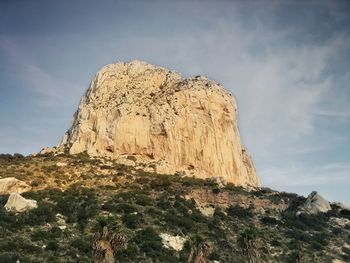 Low angle view of rock formation against sky