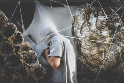 Side view of mid adult man standing by workshop