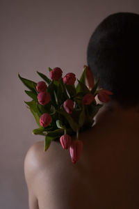 Midsection of man with flowers