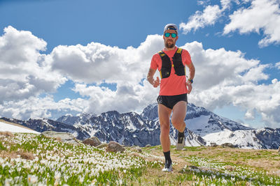 Strong trail running athlete in the mountains in training