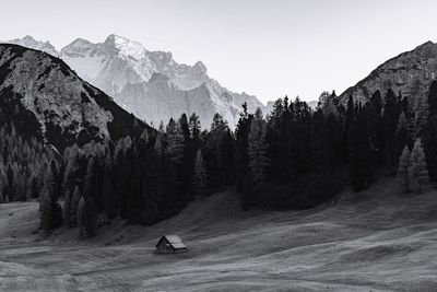 Rear view of man on mountain against clear sky