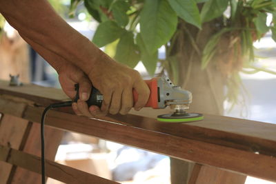 Close-up of hand working with tool on wood