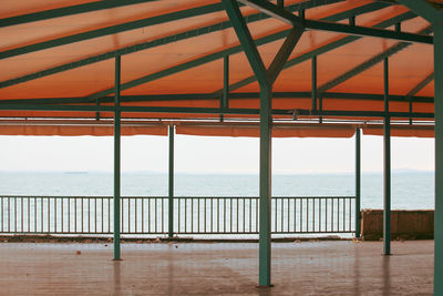 Scenic view of sea against sky seen through railing