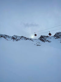 Scenic view of snow covered mountains against sky