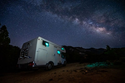 Low angle view of car on road against sky at night