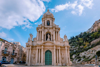 Church facade church of san bartolomeo in scicli with blue sky and white clouds