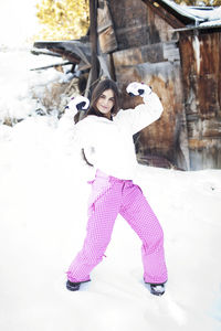 Portrait of girl standing on snow covered field