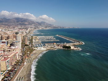 High angle view of sea and buildings against sky