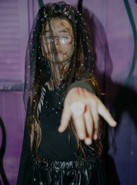Portrait of a girl with halloween makeup in a witch bride dress.
