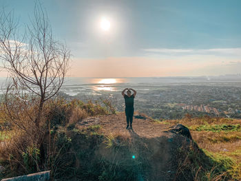 Man standing by plants against sky