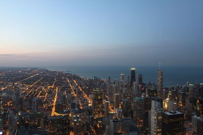 Aerial view of city lit up at night