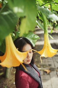 Portrait of young woman with yellow leaves