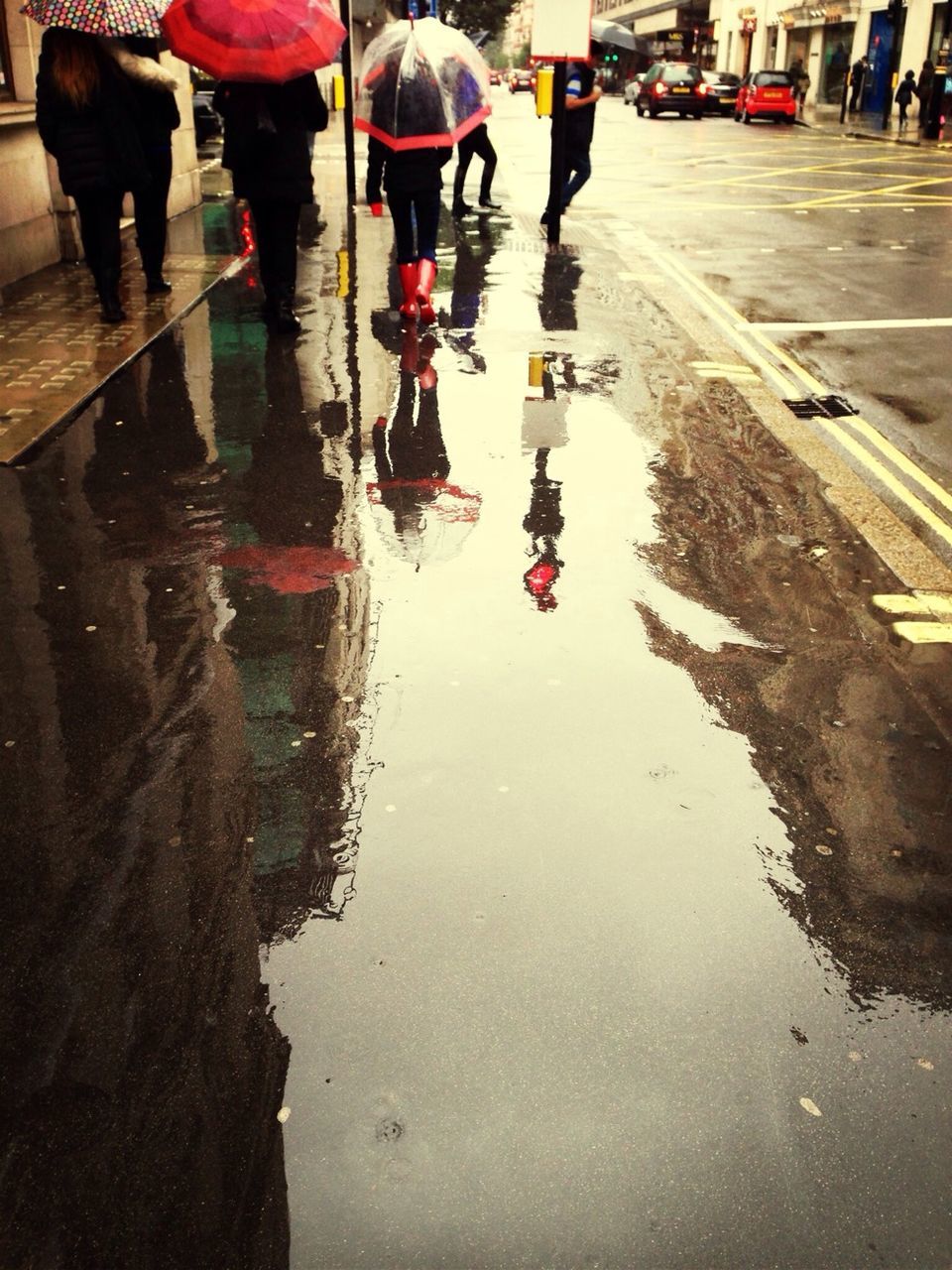 water, street, men, lifestyles, walking, person, reflection, leisure activity, wet, large group of people, city life, waterfront, medium group of people, low section, transportation, outdoors, road, group of people