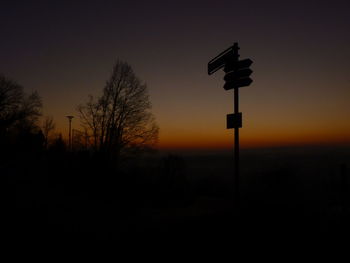 Silhouette trees against sky at night