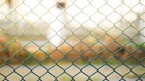 Full frame shot of chainlink fence against field