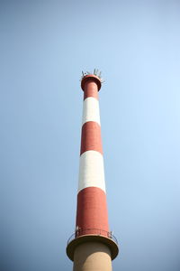 Low angle view of communications tower against clear sky