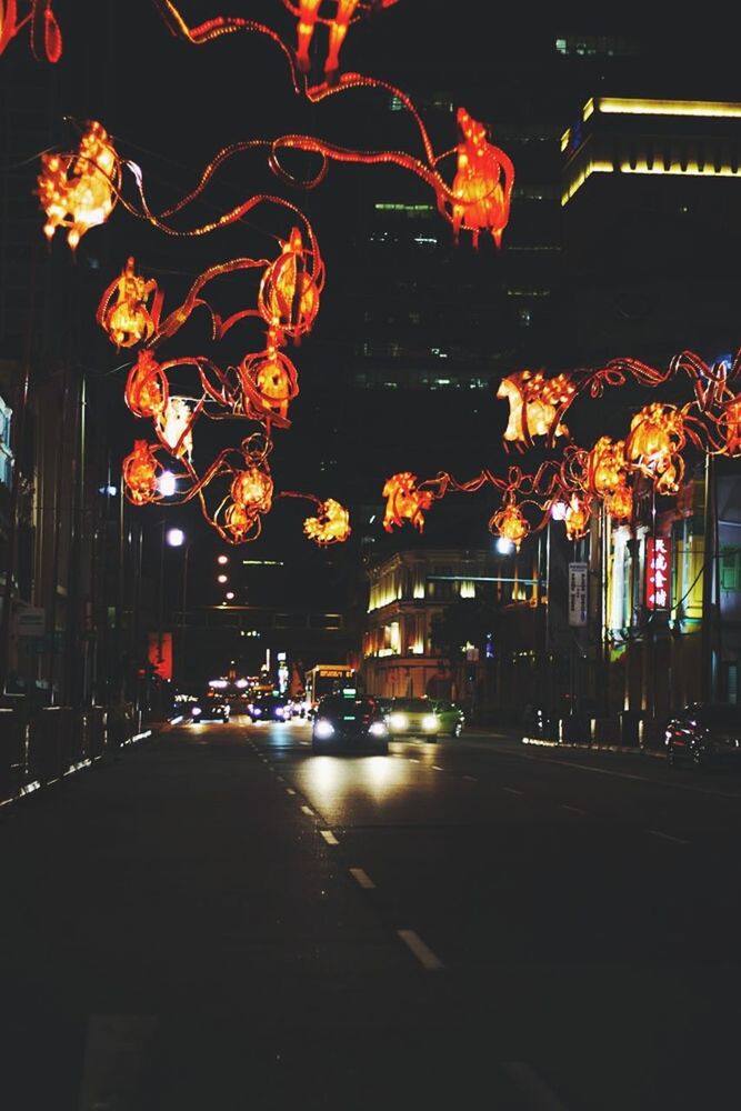 night, illuminated, street, lighting equipment, building exterior, street light, built structure, city, architecture, road, transportation, light - natural phenomenon, outdoors, incidental people, decoration, tree, city life, dark, glowing, no people