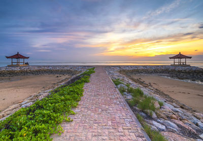 Scenic view of beach against sky during sunset