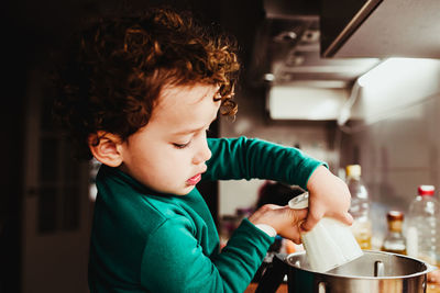 Boy holding ice cream at home