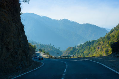 Road amidst mountains against sky