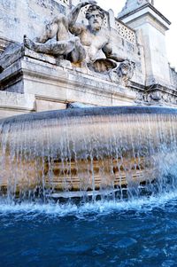 Statue of building with water in background