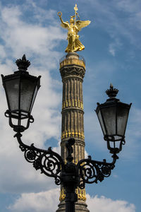 Low angle view of statue against cloudy sky