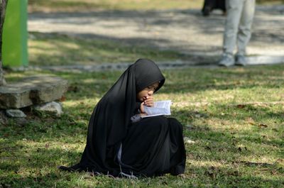 Woman sitting on field