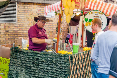 People standing at market stall