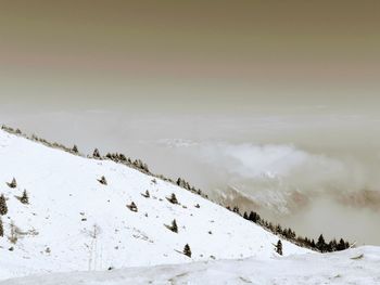 Scenic view of snow covered mountains against sky