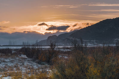 Scenic view of lake against sky during sunset