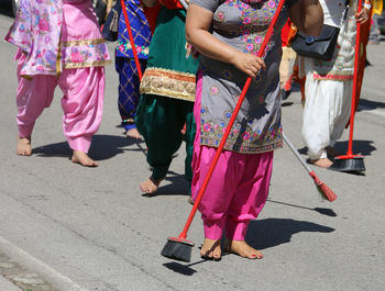 Low section of people walking on road