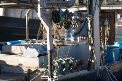 Pulleys with strings on boat at harbor