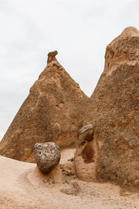 Low angle view of rock formation on land against sky