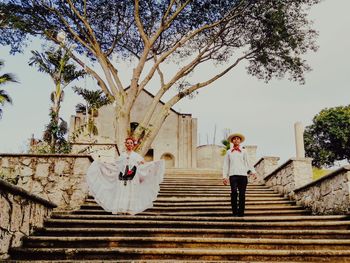 Rear view of people walking on staircase