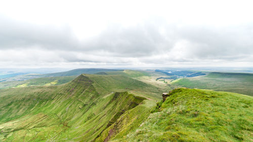 Scenic view of green landscape against sky