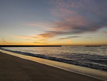 Scenic view of beach against sky during sunset