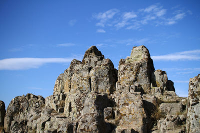 Low angle view of rock formation against sky