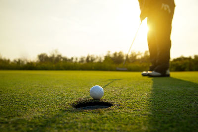 Low section of man standing on golf course