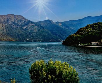 Scenic view of sea and mountains against sky