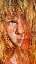 Close-up of cute girl with tousled hair looking away