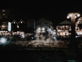 Wet illuminated city at night