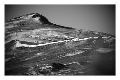 Scenic view of sand dunes against clear sky