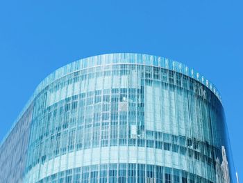 Low angle view of skyscraper against clear blue sky