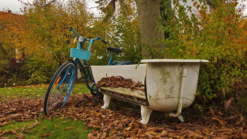 Bicycle parked on field during autumn
