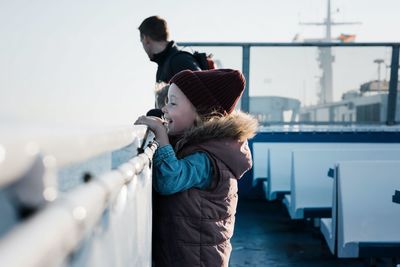 Young girl looking excited whilst travelling on a ferry boat