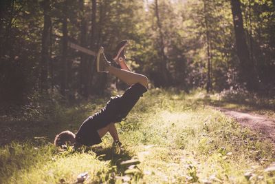 Side view of man on field in forest