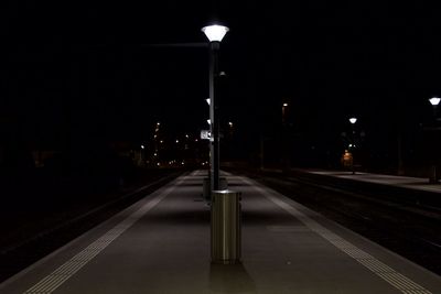 Illuminated road in city at night