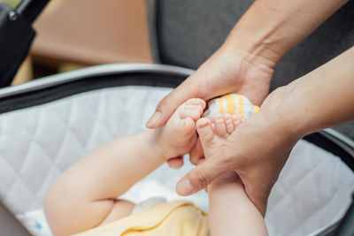 Newborn baby skin care. close up mother holding newborn baby in hands on nature background. outdoor