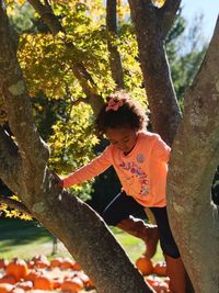 Full length of child on tree